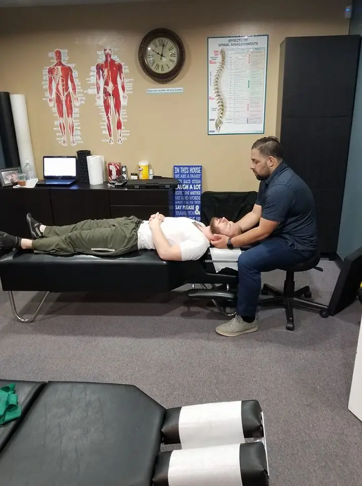Chiropractor performing a gentle neck adjustment