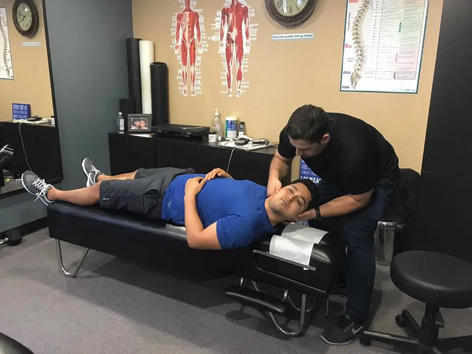 Dr. Eric Perez performing a spinal adjustment