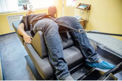 Patient on a spinal decompression table