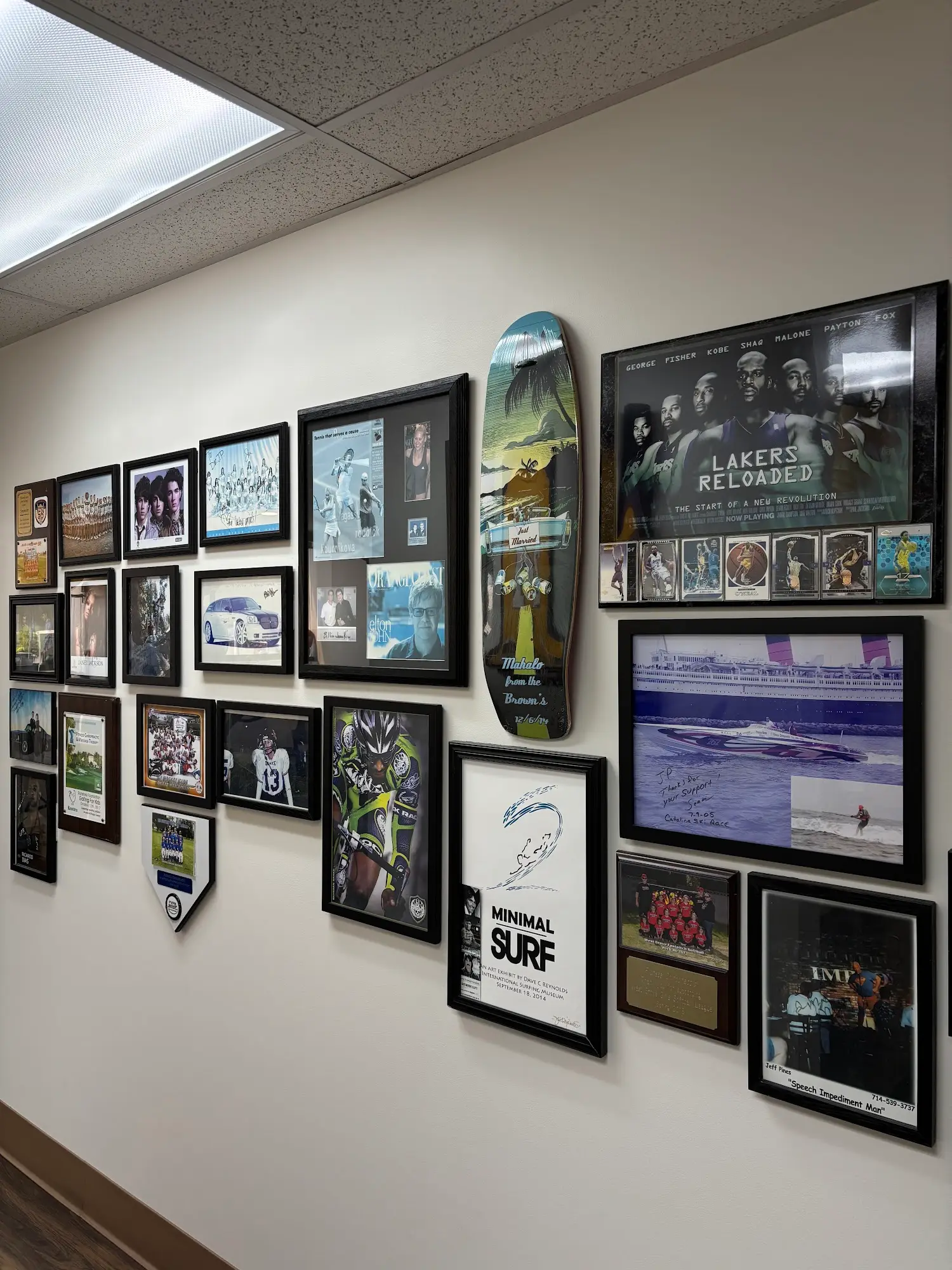 Wall of signed athlete photos in the Huntington Beach office